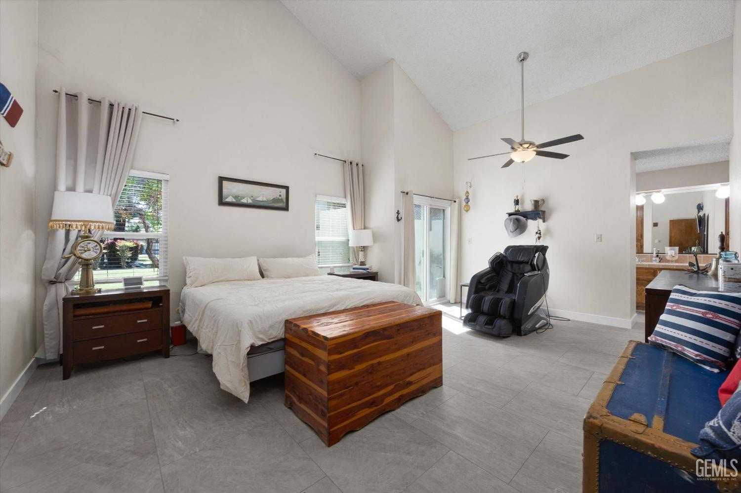 Undisclosed Address Bakersfield, CA 93309 - Photo 23 of 35 a spacious bedroom with a bed and a chandelier