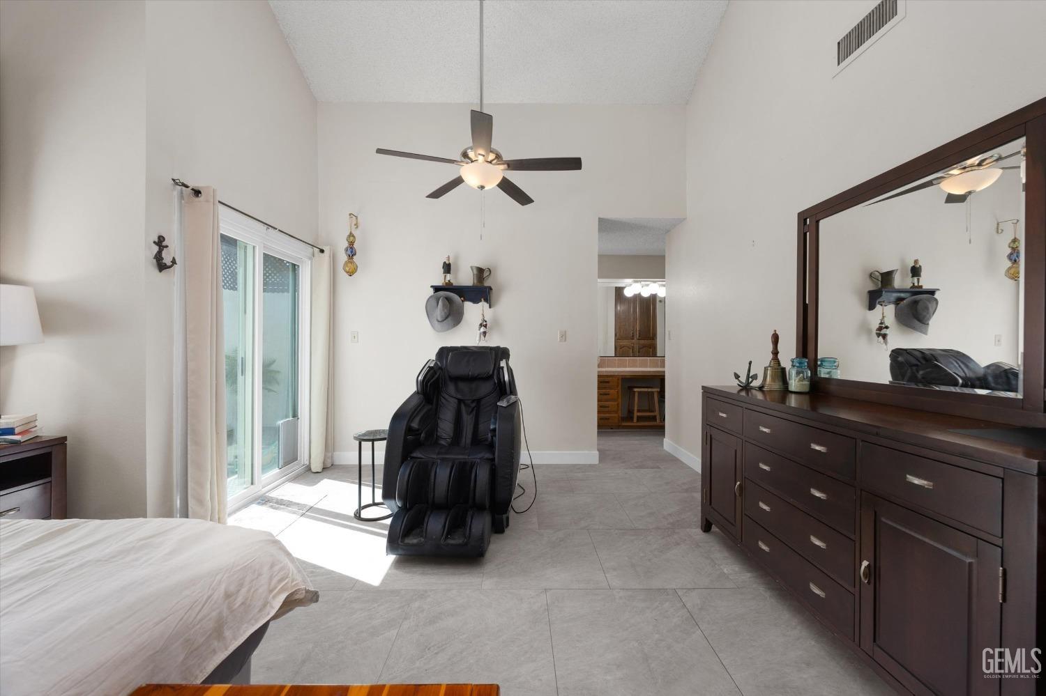 Undisclosed Address Bakersfield, CA 93309 - Photo 25 of 35 a bed room with a bed and a dresser