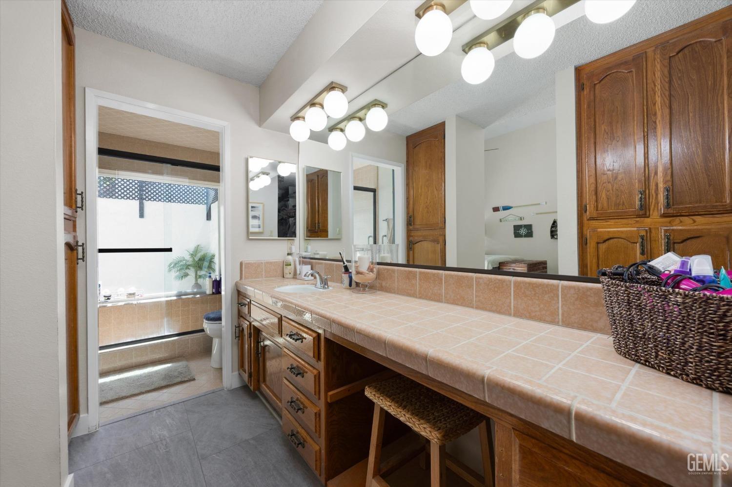 Undisclosed Address Bakersfield, CA 93309 - Photo 26 of 35 a spacious bathroom with a sink double vanity granite and a shower