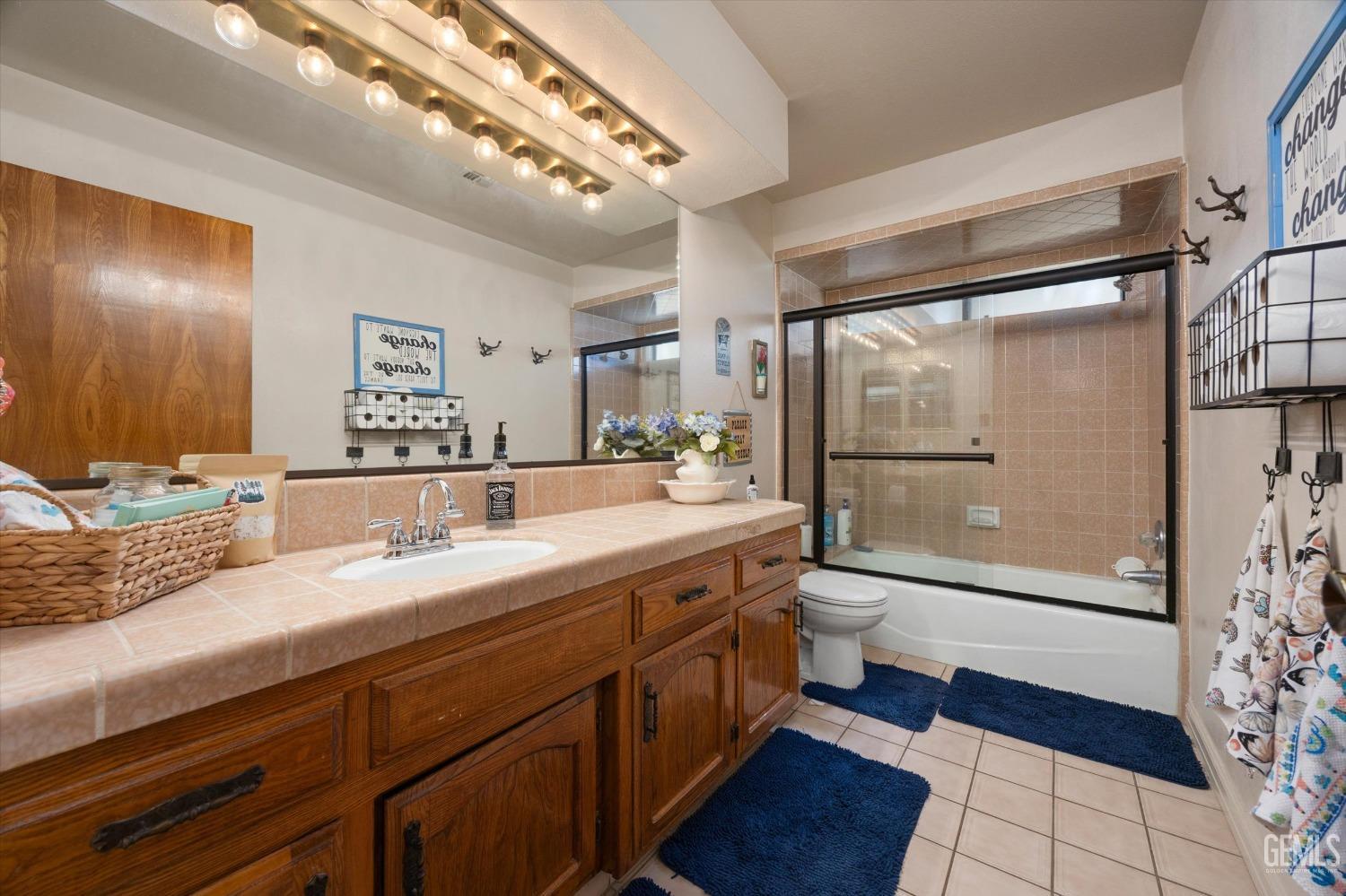 Undisclosed Address Bakersfield, CA 93309 - Photo 30 of 35 a spacious bathroom with a granite countertop sink mirror and shower
