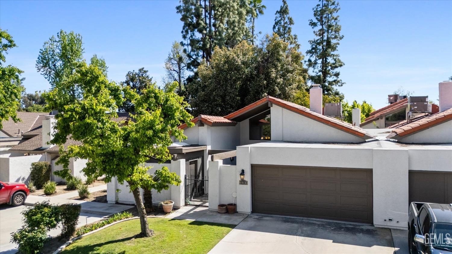 Undisclosed Address Bakersfield, CA 93309 - Photo 3 of 35 a front view of a house with garden
