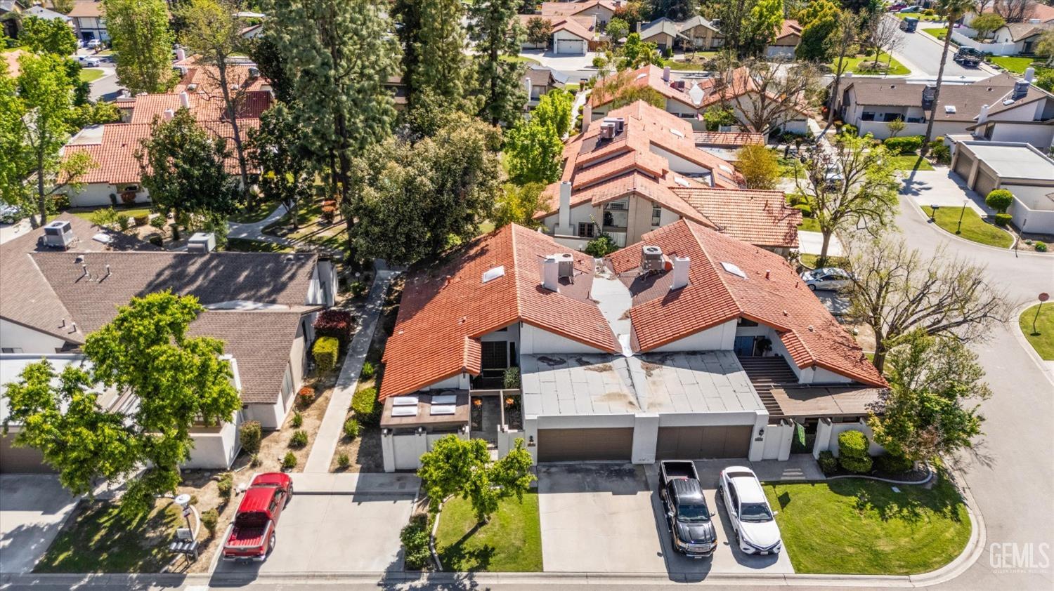 Undisclosed Address Bakersfield, CA 93309 - Photo 4 of 35 an aerial view of a house with a yard potted plants and large tree