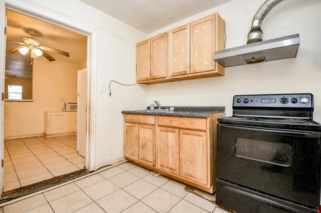 a kitchen with stainless steel appliances granite countertop a stove and a microwave