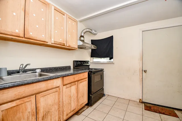 a kitchen with stainless steel appliances granite countertop a sink and a stove