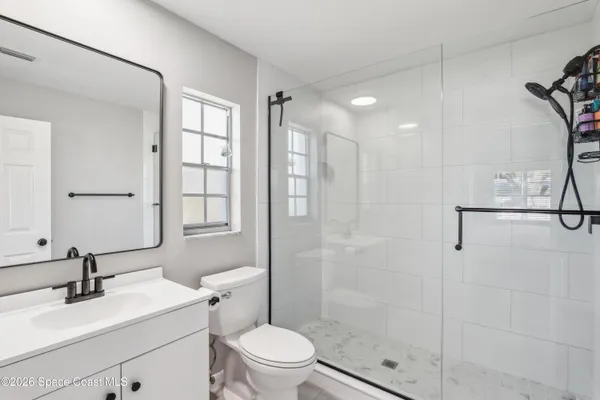 a bathroom with a sink toilet and shower