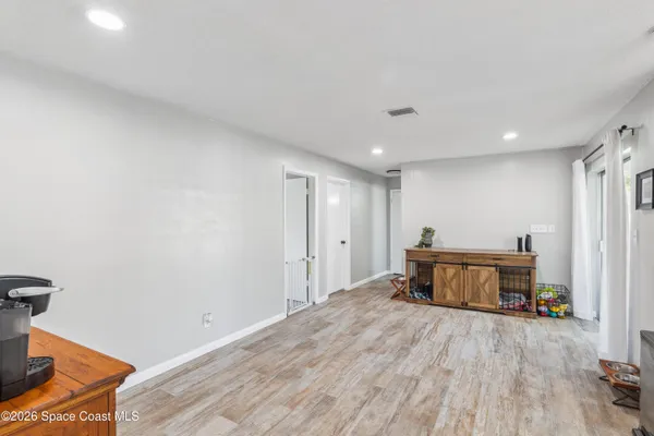 a empty room with wooden floor and furniture