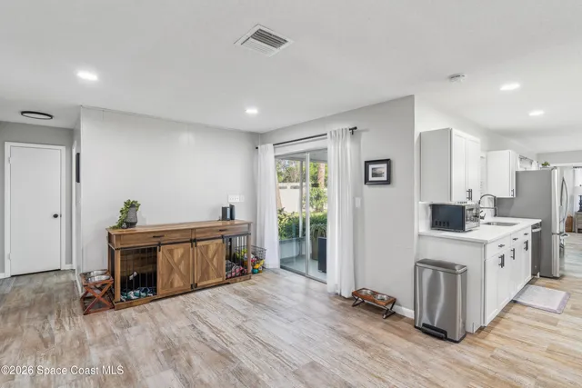 a view of a room with wooden floor and furniture