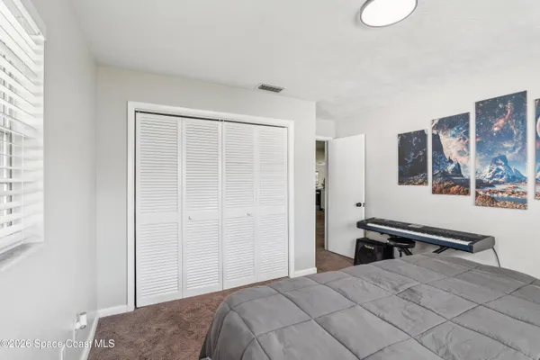 a bedroom with a bed and a desk