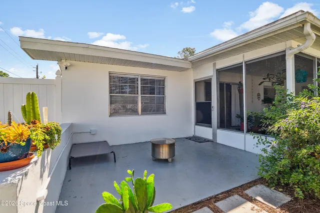 a front view of a house with outdoor seating