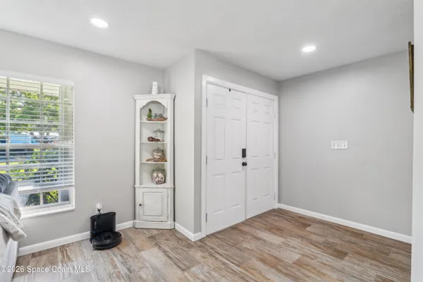 a view of a livingroom with wooden floor and windows