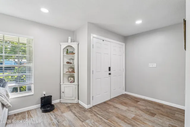 a view of a livingroom with wooden floor and windows