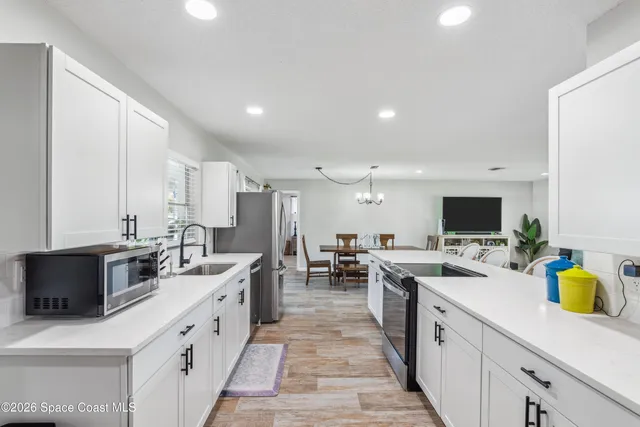 a kitchen with lots of counter top space and stainless steel appliances