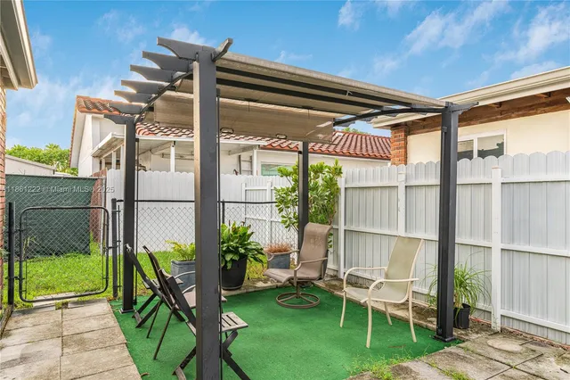 a view of a back yard with an empty space and chair