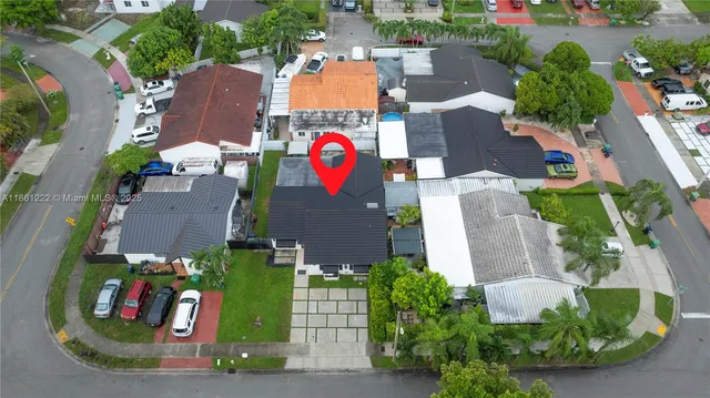 an aerial view of a house with a yard