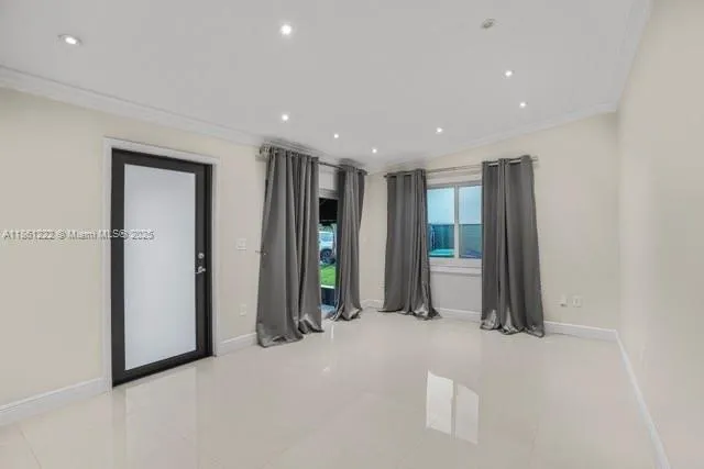 a view of an empty room with glass door