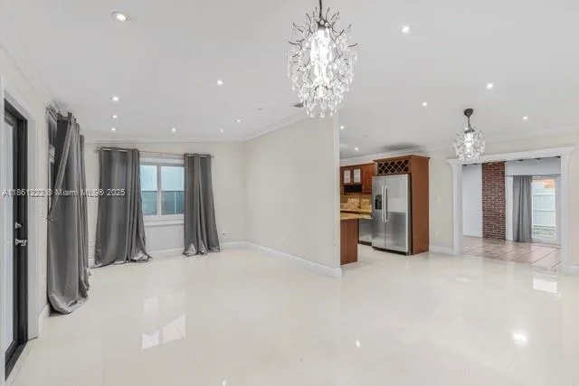 a view of a kitchen with a refrigerator and a sink