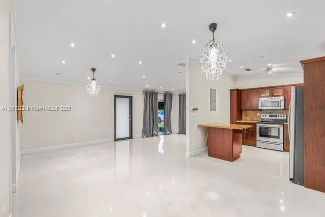 a view of kitchen with stainless steel appliances refrigerator oven and stove