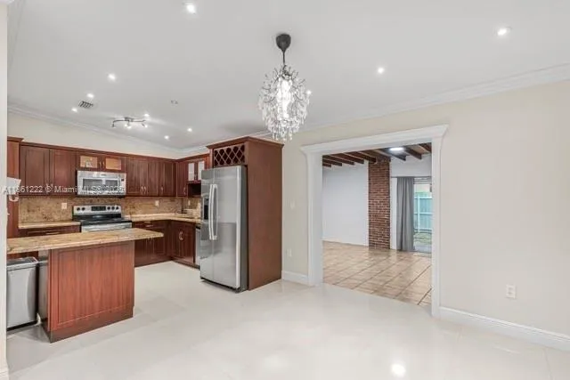 a view of a kitchen with a sink and stainless steel appliances