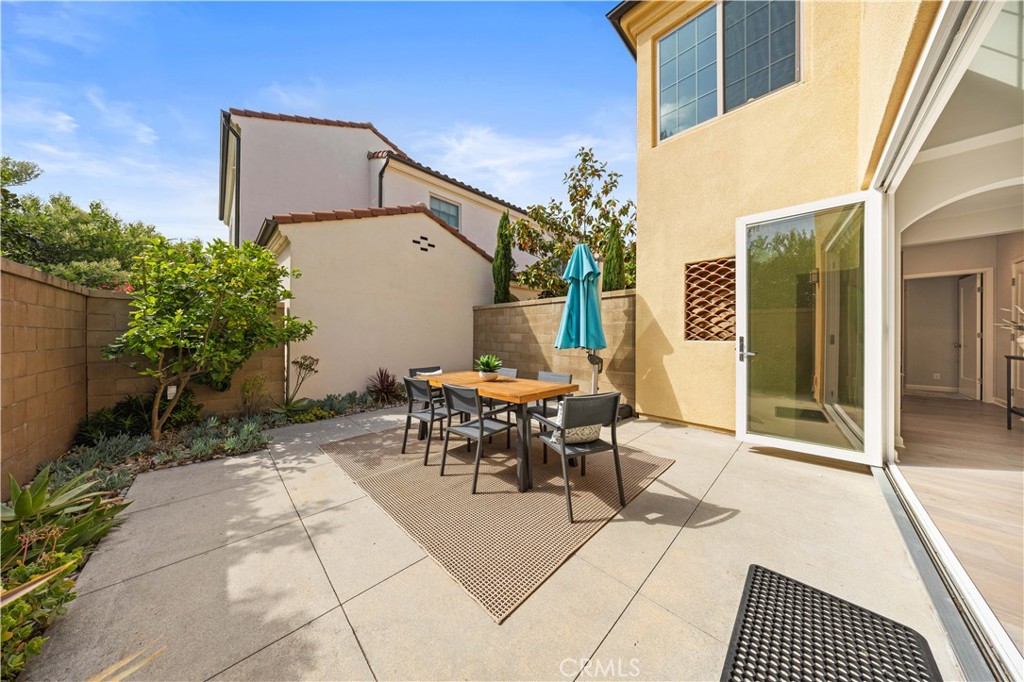 105 Copeland Irvine, CA 92618 - Photo 16 of 46 a patio with table and chairs and potted plants