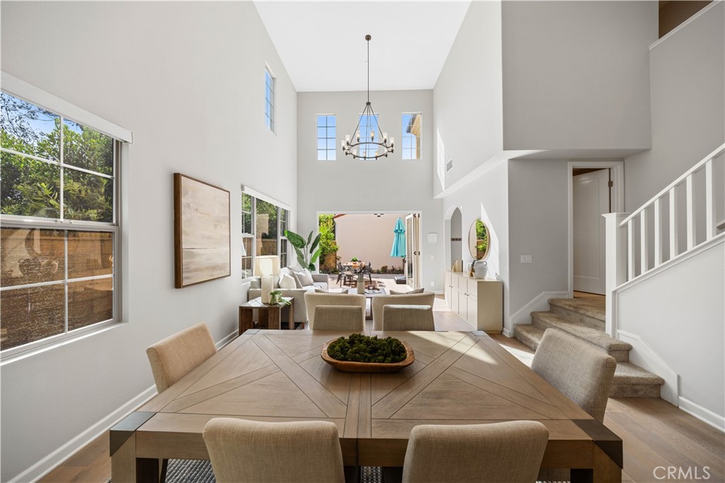 105 Copeland Irvine, CA 92618 - Photo 18 of 46 a view of a dining room with furniture a potted plant and a chandelier