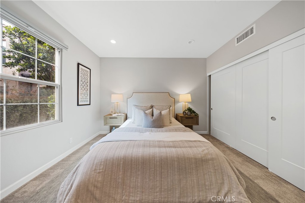 105 Copeland Irvine, CA 92618 - Photo 23 of 46 a large bed sitting in a bedroom next to a window