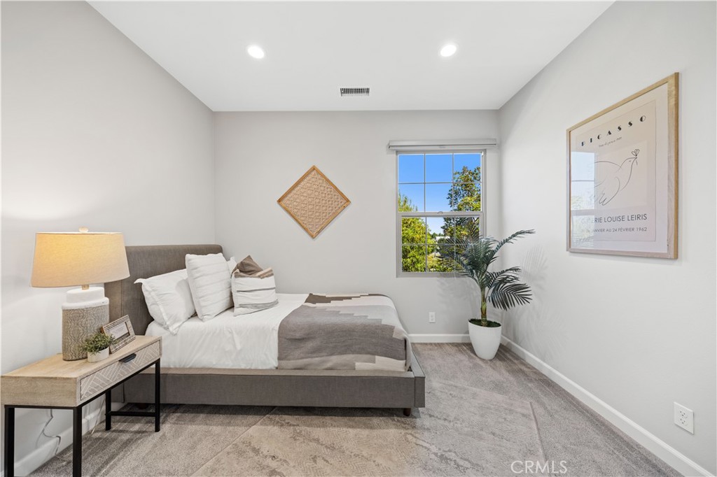 105 Copeland Irvine, CA 92618 - Photo 28 of 46 a bedroom with a bed and a potted plant on dresser