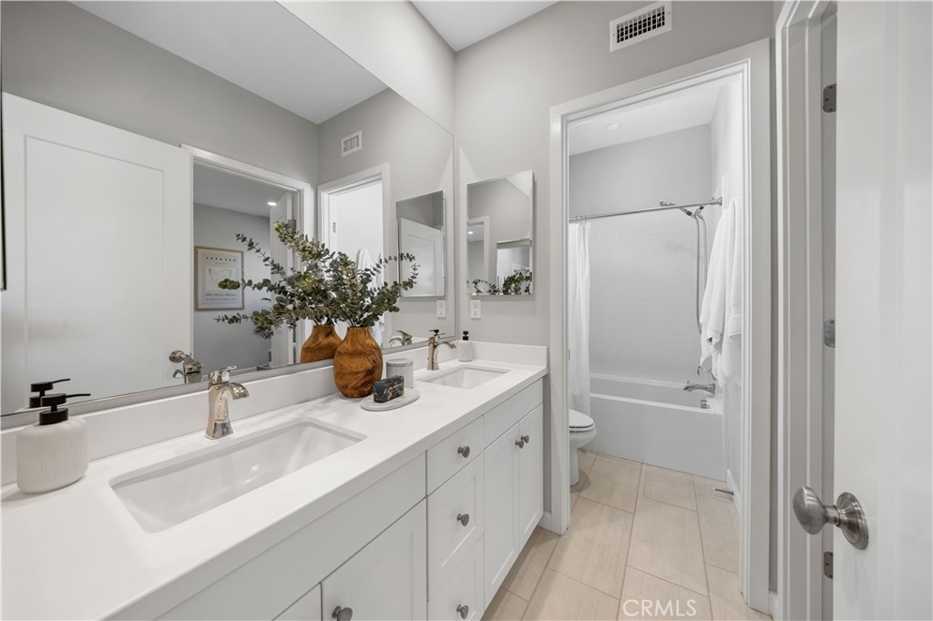 105 Copeland Irvine, CA 92618 - Photo 30 of 46 a bathroom with a double vanity sink mirror and shower