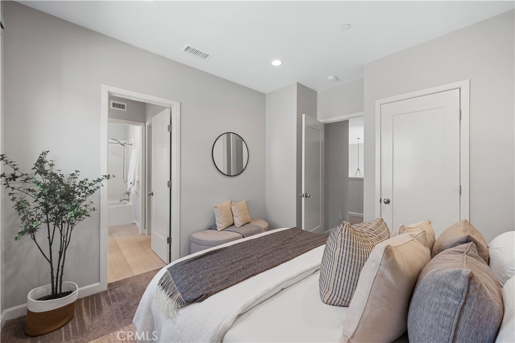 105 Copeland Irvine, CA 92618 - Photo 32 of 46 a bedroom with a bed and a potted plant