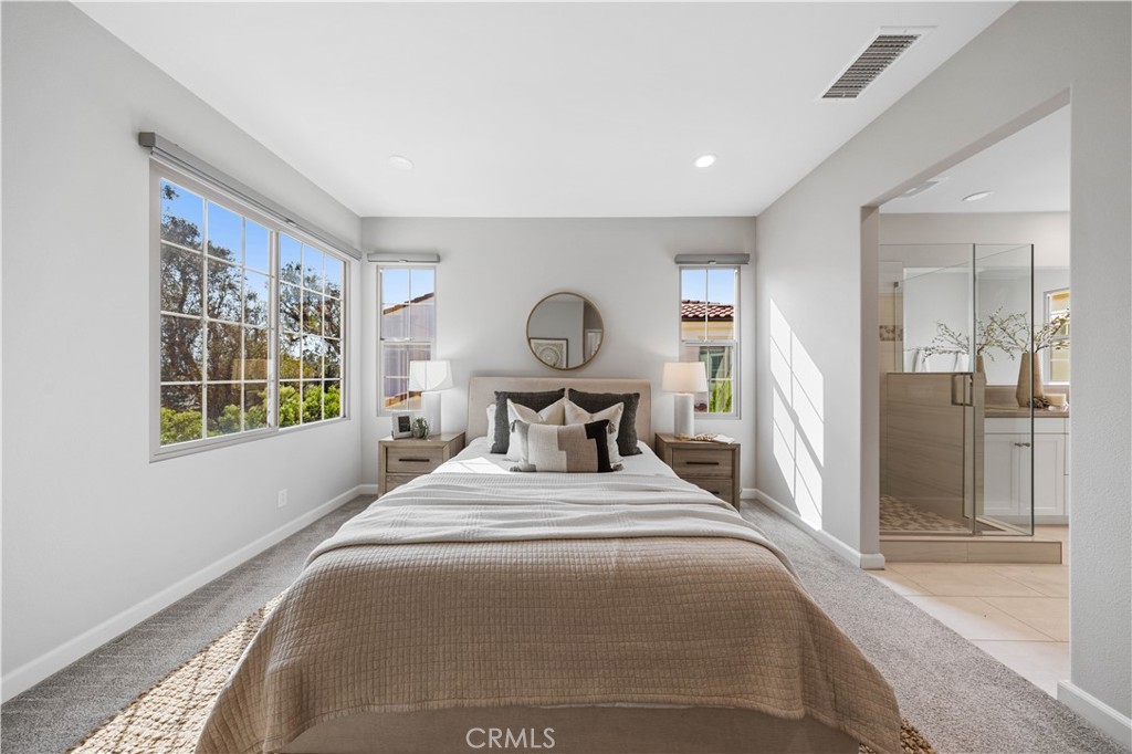 105 Copeland Irvine, CA 92618 - Photo 34 of 46 a bedroom with a bed and a large mirror next to a window