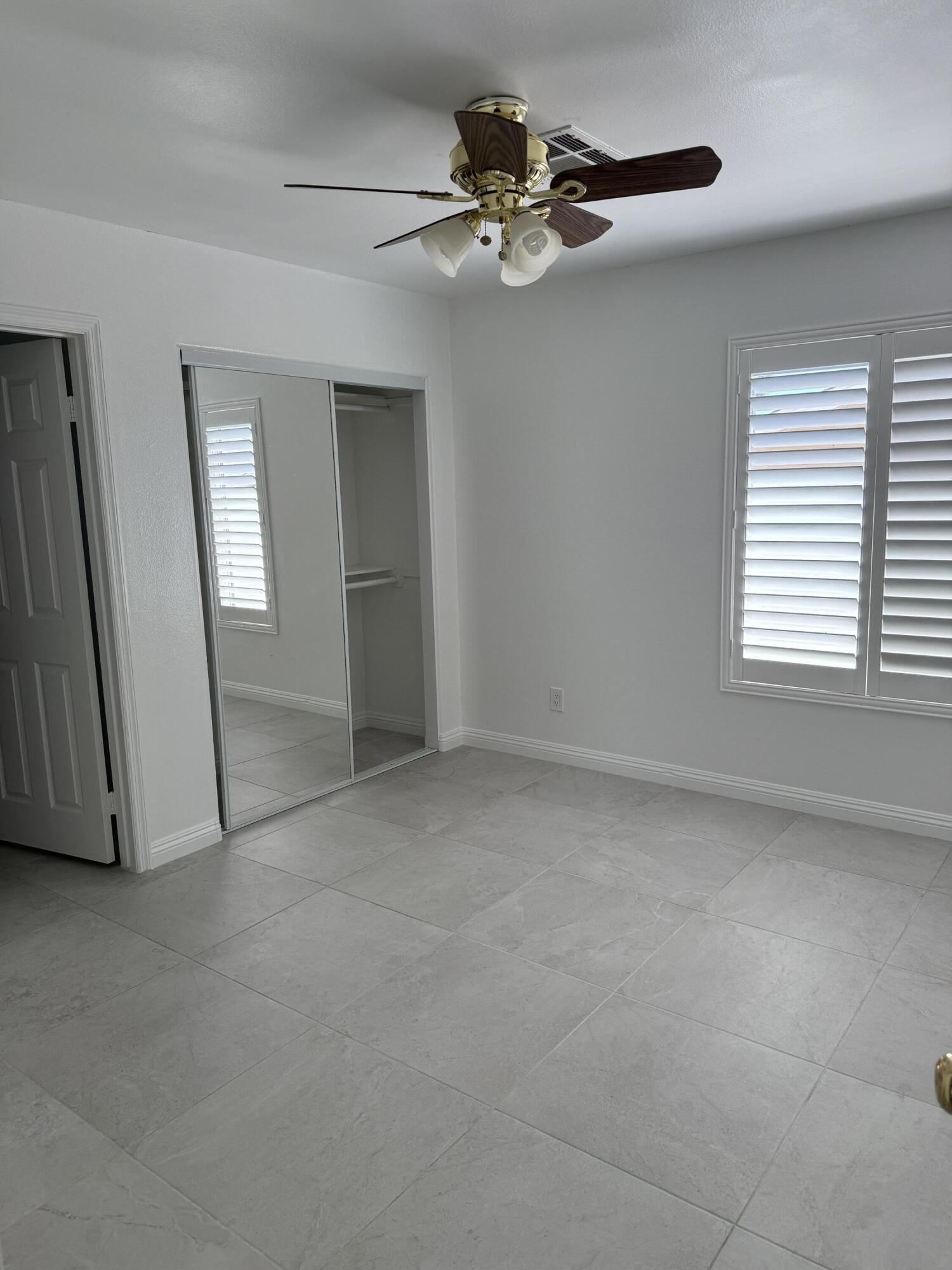 32790 Aurora Vista Road Cathedral City, CA 92234 - Photo 12 of 18 a view of a livingroom with a ceiling fan and window