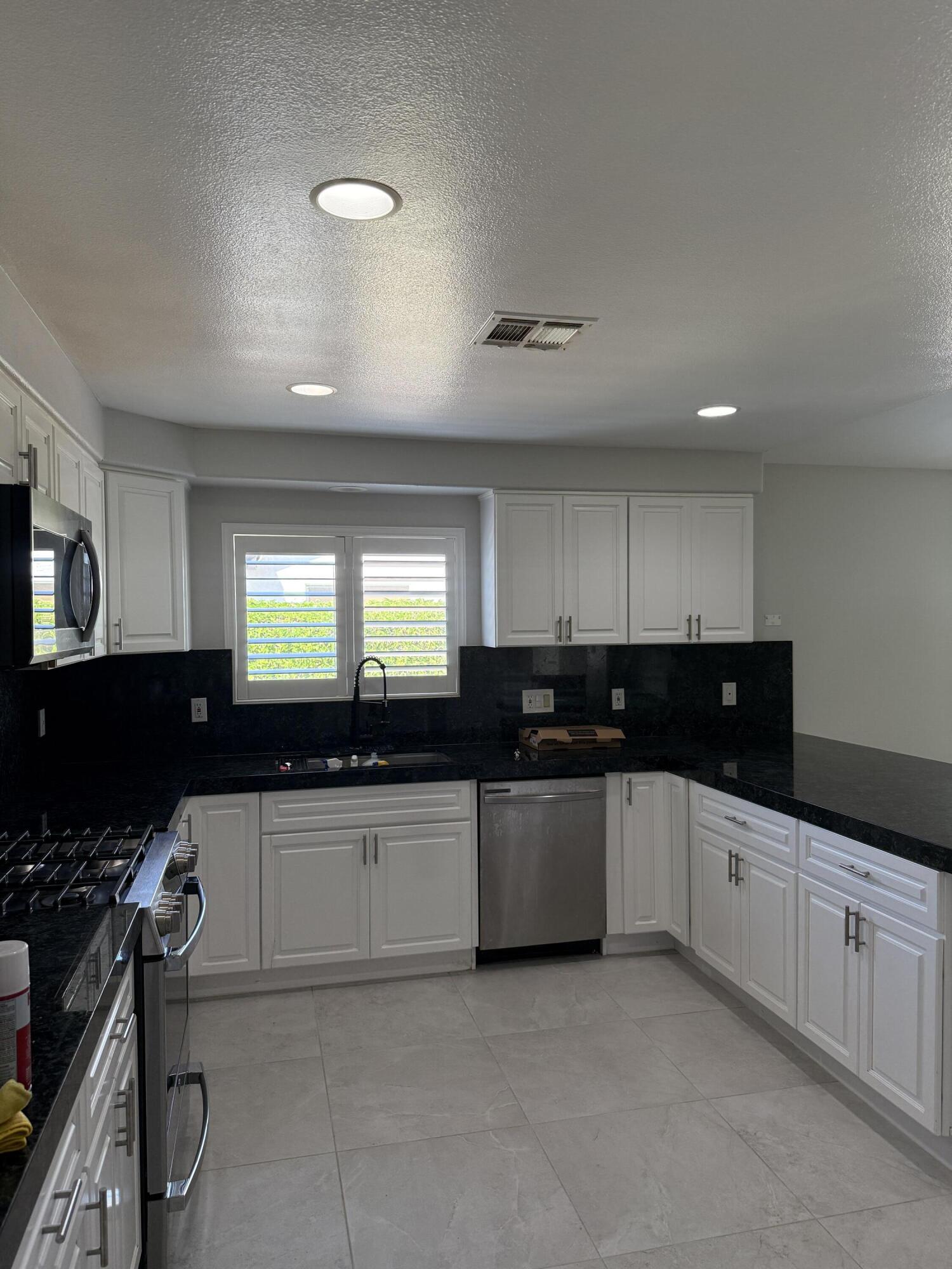 32790 Aurora Vista Road Cathedral City, CA 92234 - Photo 2 of 18 a kitchen with granite countertop a sink and a stove