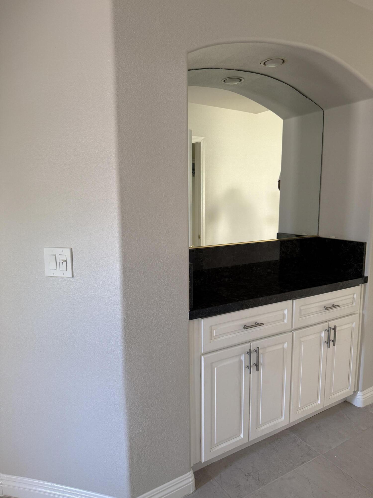 32790 Aurora Vista Road Cathedral City, CA 92234 - Photo 7 of 18 a kitchen with white cabinets and a sink