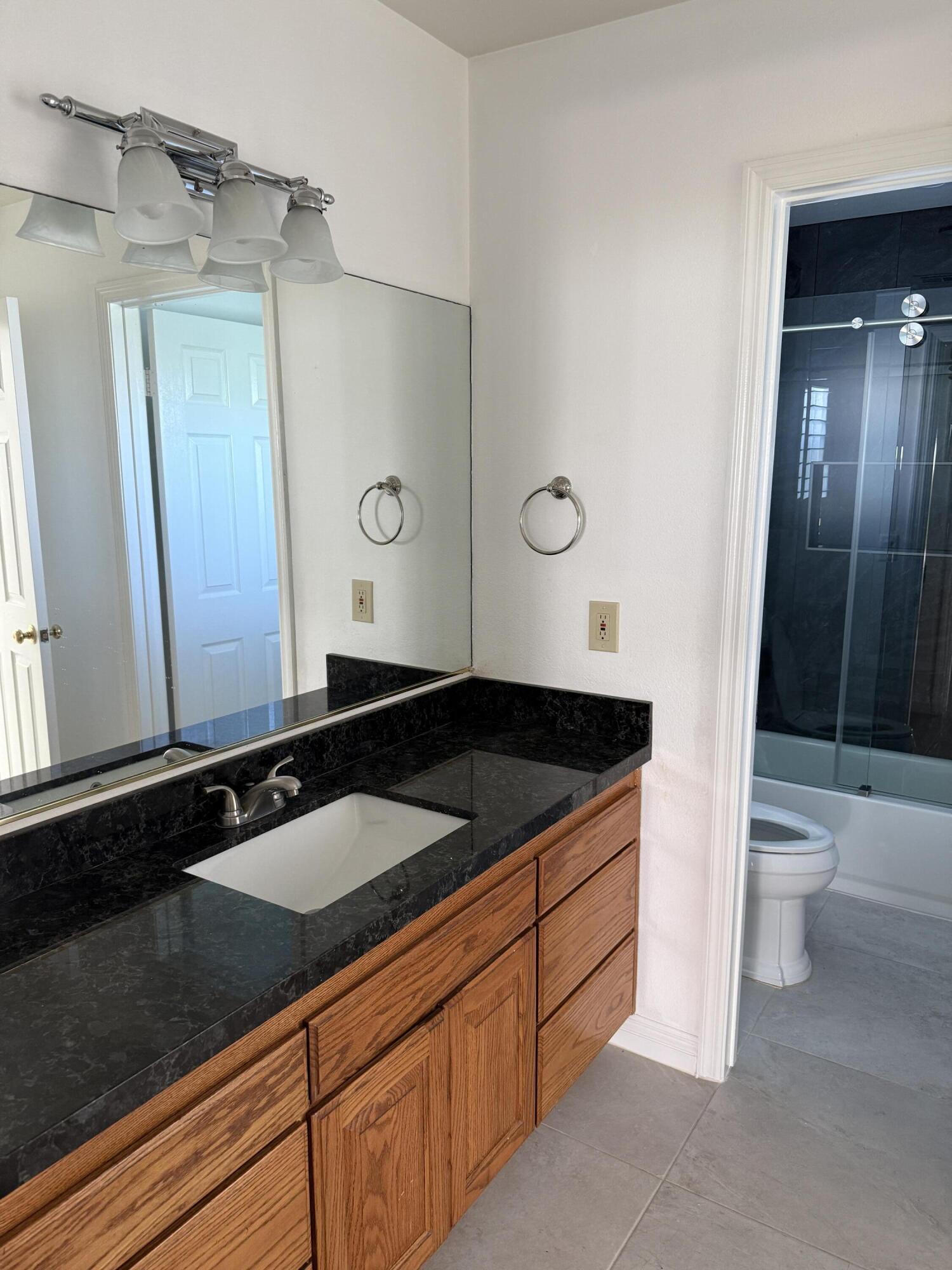32790 Aurora Vista Road Cathedral City, CA 92234 - Photo 8 of 18 a bathroom with a granite countertop sink and a mirror