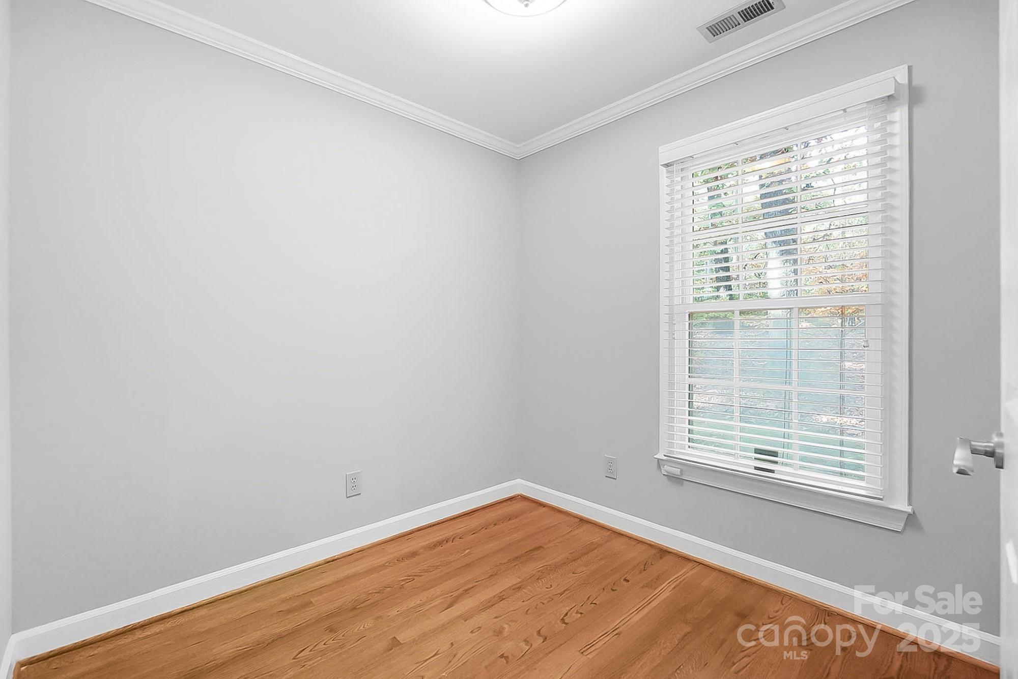 3475 Pikeview Road Fort Mill, SC 29715 - Photo 11 of 48 a view of an empty room with wooden floor and a window