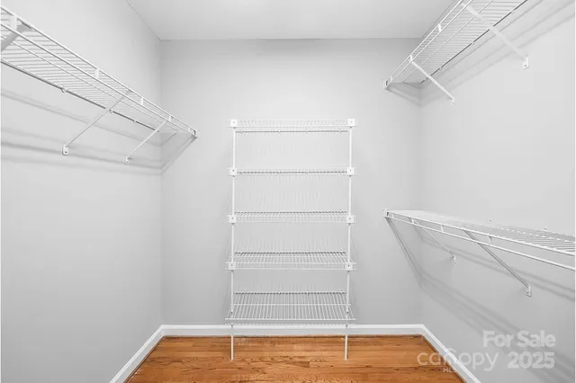 a view of walk in closet with empty racks