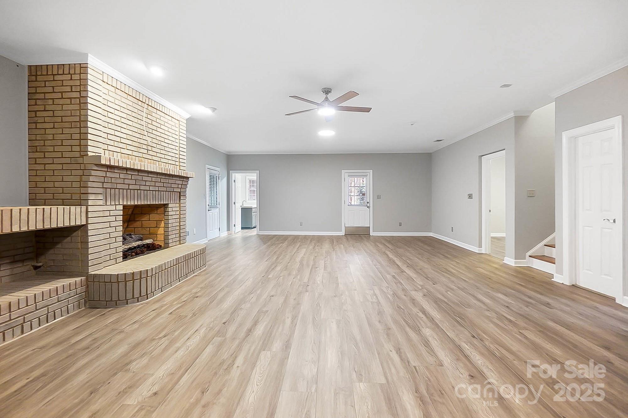 3475 Pikeview Road Fort Mill, SC 29715 - Photo 29 of 48 wooden floor in an empty room with a fireplace