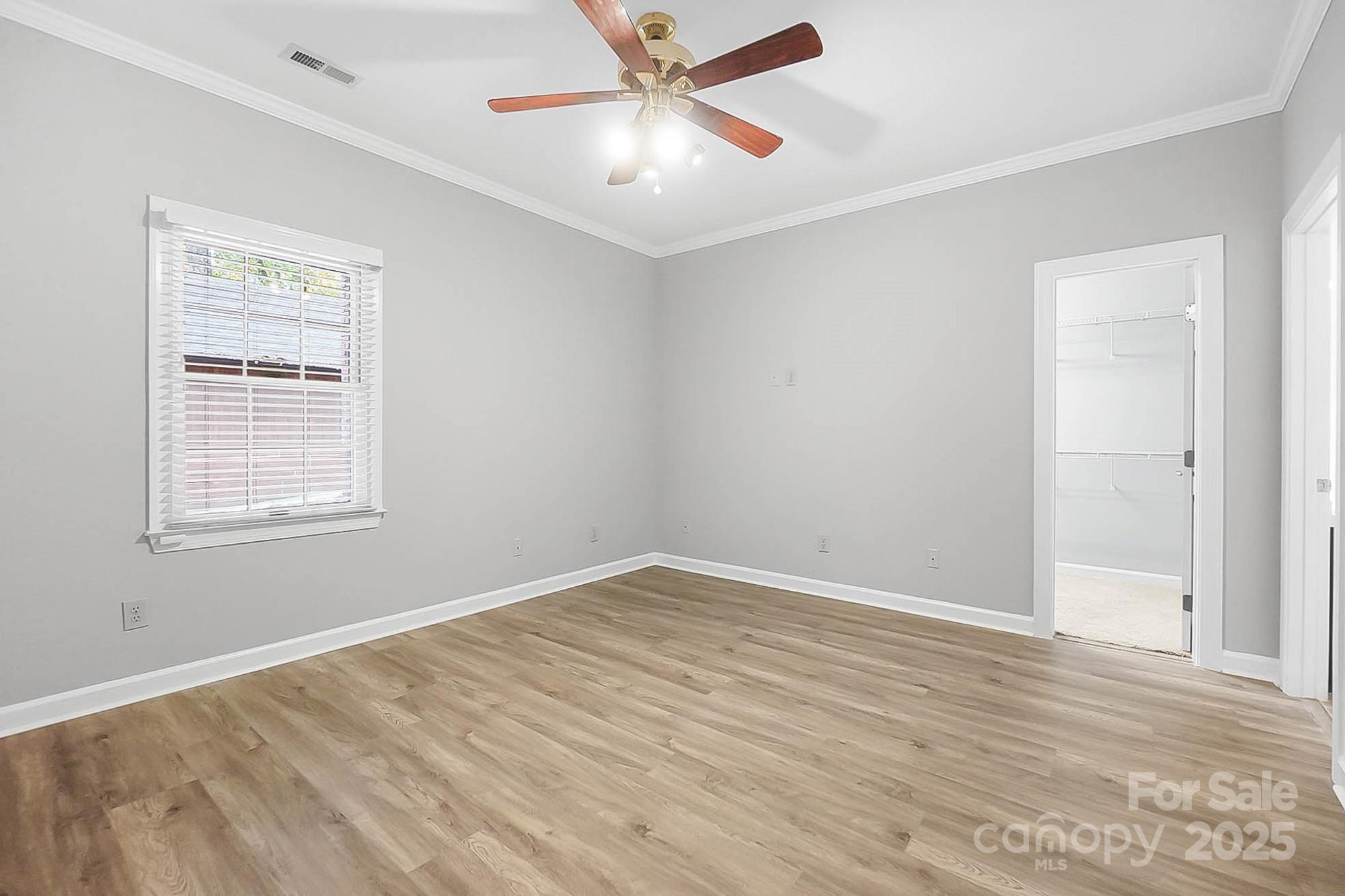 3475 Pikeview Road Fort Mill, SC 29715 - Photo 31 of 48 an empty room with wooden floor ceiling fan and windows