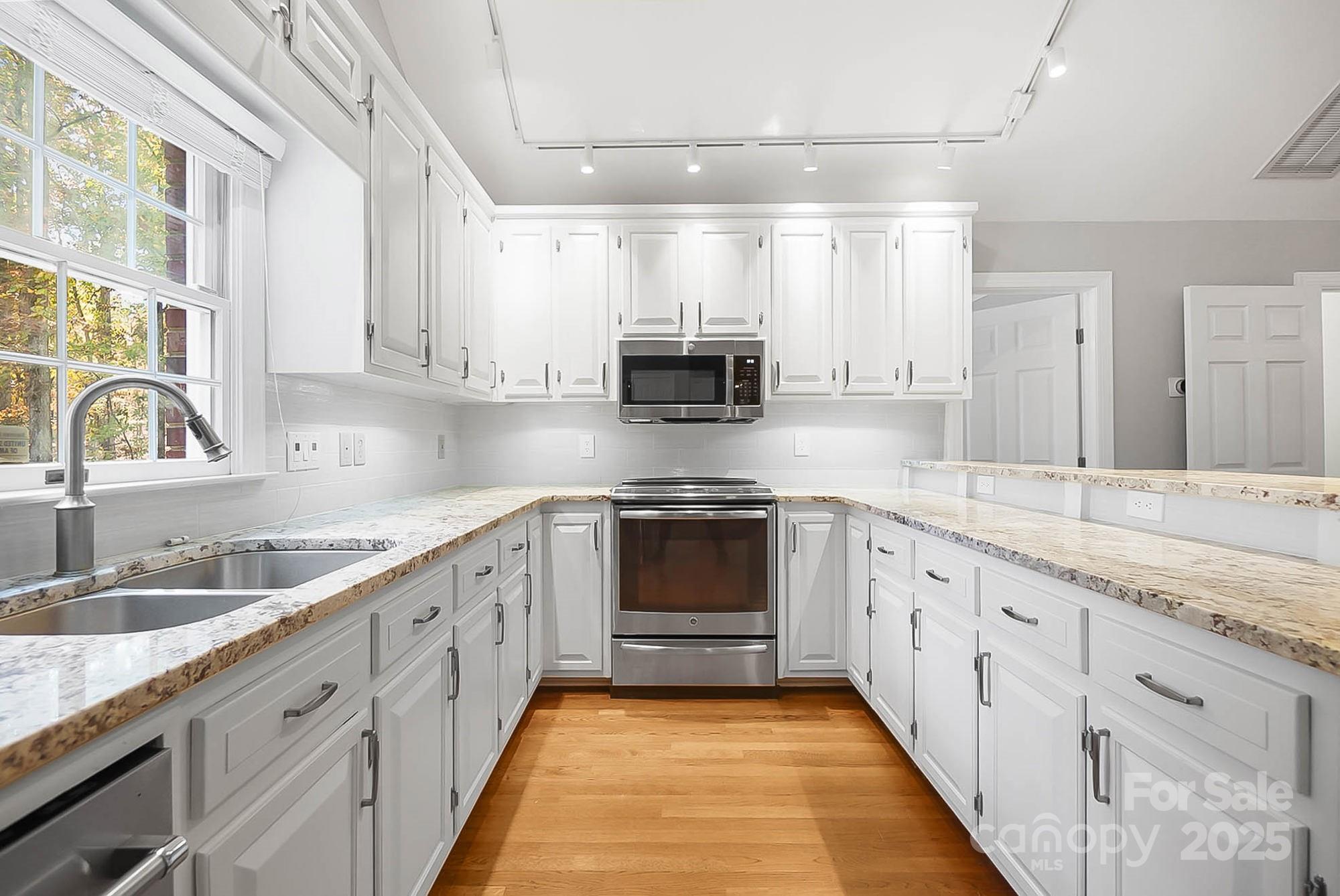 3475 Pikeview Road Fort Mill, SC 29715 - Photo 6 of 48 a kitchen with granite countertop a sink stove and cabinets
