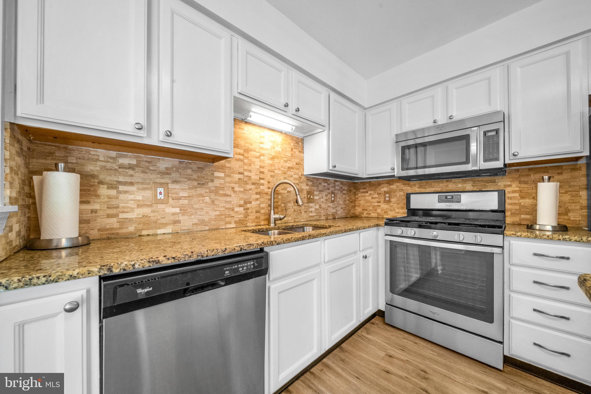 8596 Cold Harbor Loop Manassas, VA 20111 - Photo 18 of 52 a kitchen with granite countertop cabinets stainless steel appliances and a counter space