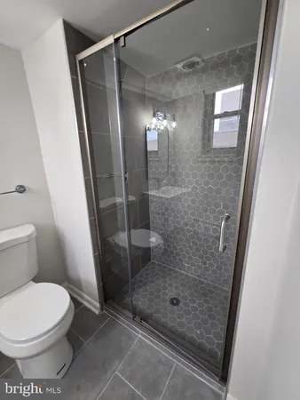 a bathroom with a glass door shower
