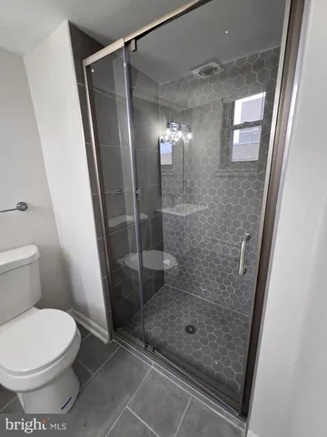 a bathroom with a glass door shower