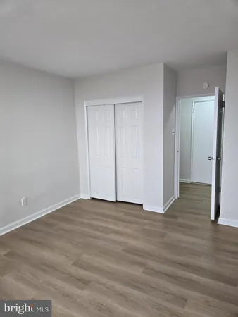 a view of an empty room and wooden floor