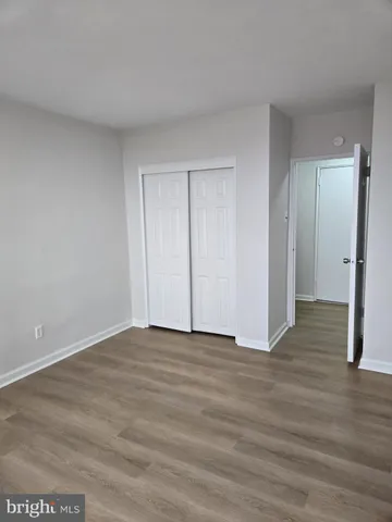 a view of an empty room and wooden floor