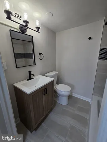a bathroom with a sink a toilet and mirror
