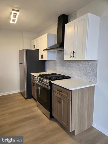 a kitchen with stainless steel appliances a stove a refrigerator and a sink