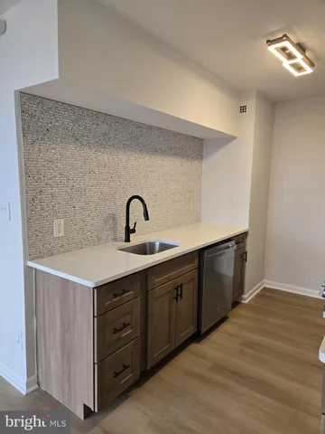 a kitchen with cabinets a sink and dishwasher