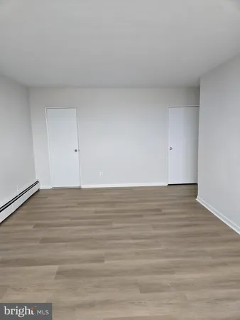a view of an empty room and wooden floor