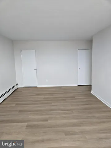 a view of an empty room and wooden floor