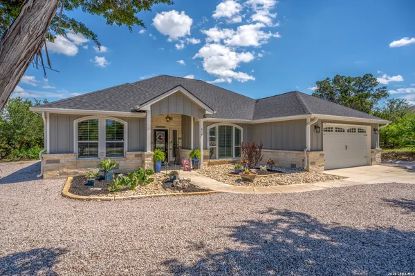 a front view of a house with garden and patio