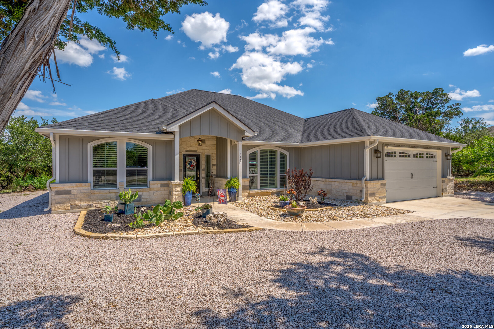 819 Primrose Path Spring Branch, TX 78070 - Photo 1 of 17 a front view of a house with garden and patio